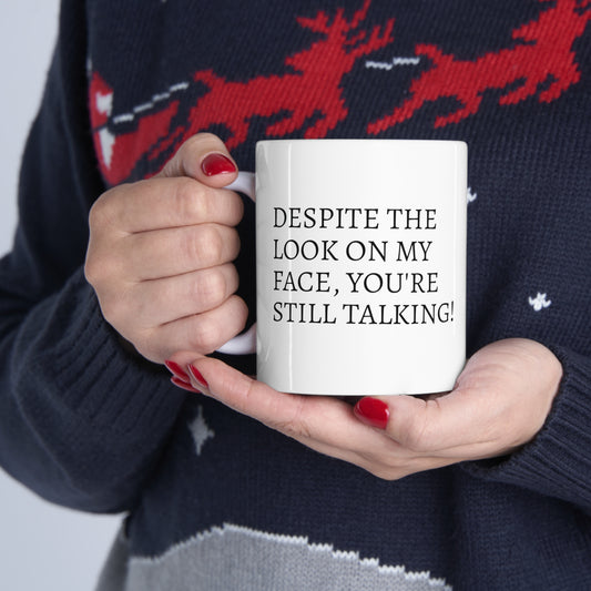 Funny "Despite the look on my face, you're still talking" Mug